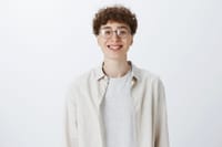 cheerful-attractive-teenage-guy-posing-against-white-wall.jpg